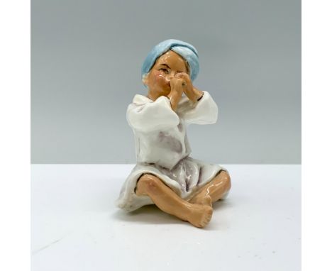 Bone china figure of a boy in a white robe and blue head wrap playing a flute. Royal Worcester backstamp. Issued: 20th c.Dime