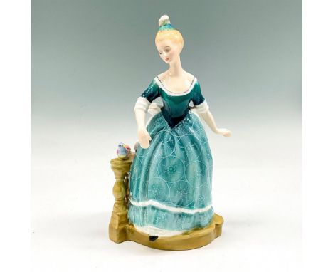 Part of the Classics Pretty Ladies collection, this figural is dressed in aquamarine gown with a delicate design, standing on