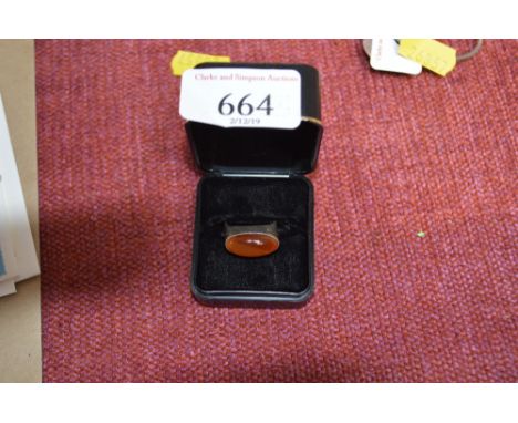 A white metal and amber dress ring