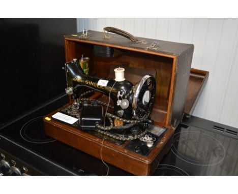 A Singer electric sewing machine, in carrying case, sold as a collector's item