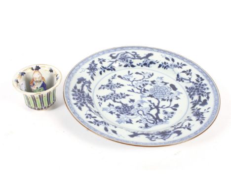 A 19th century Chinese blue and white plate and a cup. The first decorated with blossom, diam 27.5cm, the novelty cup decorat
