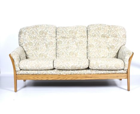 A modern slatted frame three-seater sofa and two armchairs. Upholstered in cream ground pale green tapestry style foliate pat