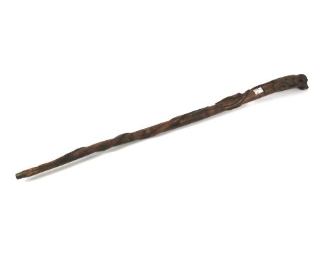 A 20th century carved wooden walking stick. Of tribal influence, with carved depiction of a mongoose fighting a large cobra, 