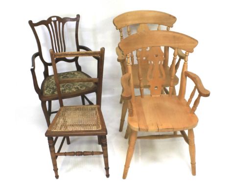 A pair of farmhouse armchairs and three others. To include a mahogany ladder back chair with rush seat, largest approximately