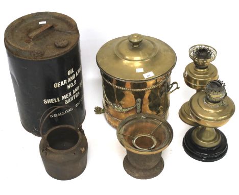 An assortment of metalware. Including brass oil lamp bases, ice bucket, vintage oil can, etc