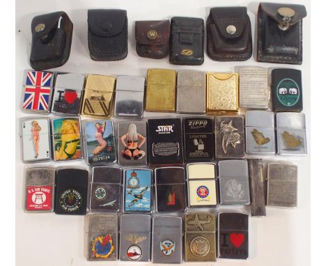 A collection of cigarette lighters, comprising silver-plated examples by Dupont and Dunhill, the remainder being either Zippo