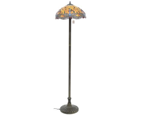 A 20th century Tiffany style standard lamp with leaded stained glass shade decorated with dragonflies on metallic reeded upri