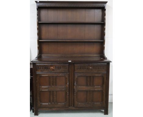 A mid 20th century Ercol kitchen dresser with two tier plate rack on base with two drawers over pair of cabinet doors, 177cm 