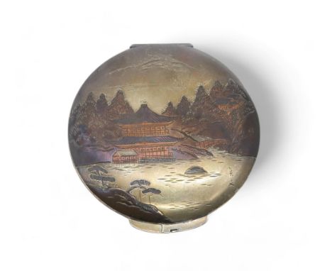 A Japanese silver niello compact, the lid decorated with a landscape scene, 8cm diameter, 80gms Condition Report:Available up