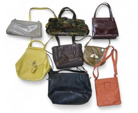 A quantity of ladies handbags, many leather including Prada, Radley, Roger etc Condition Report:Available upon request