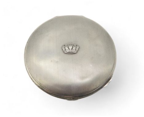 A silver circular powder compact, by Gieves ltd, with engine-turned decoration and an applied crown to the lid, original powd