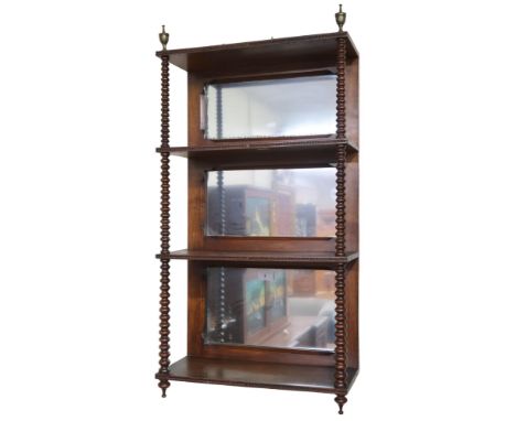A 19th century walnut four tiered mirror backed wall shelf, rectangular shelves capped with brass urn shaped finials and sepa