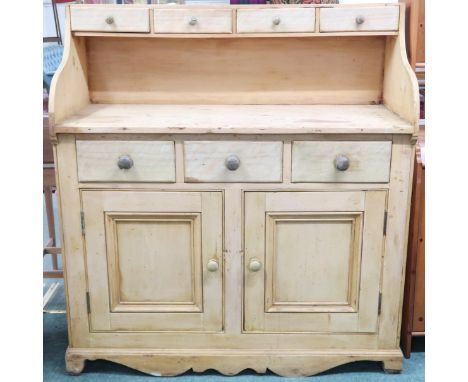 A late Victorian Scotch pine farmhouse style kitchen dresser with four short drawers over open top and three short drawers ov