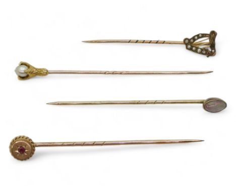 Four lapel pins, a 9ct gold pearl set harp, a bright yellow metal eagles claw set with a pearl, a black opal mounted in yello