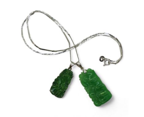 Two Chinese green hardstone pendants, with a 40cm 14k gold snake chain, dark green pendant carved with fruit & foliage, (af) 