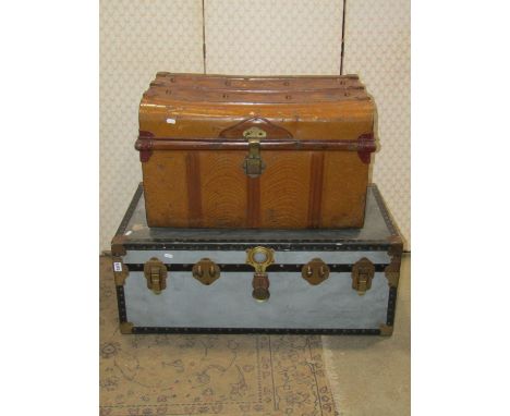 A vintage overpond fibre and reinforced trunk with metal fittings together with a Victorian tin trunk with simulated wood gra