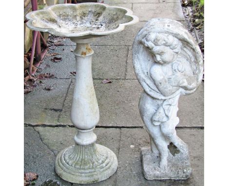 A reclaimed garden ornament in the form of a standing cherub on a tree stump grasping a cloak, 68cm high, together with a cas
