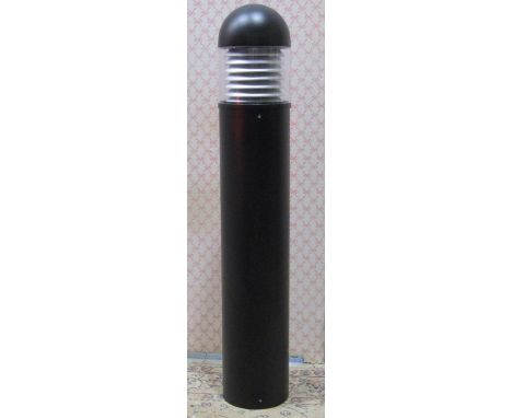 A contemporary exterior bollard shaped lamp 