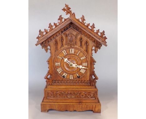 Bavarian oak Black Forest mantel cuckoo clock, with applied ivorine Roman numerals and twin train movement, 42cm high, key an