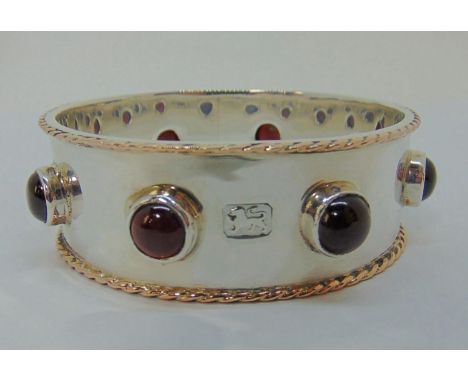 Impressive Guild of Handicrafts silver bangle set with cabochon garnets and with gold rope twist detail to edges, London 1998
