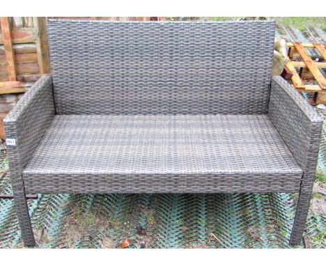 A contemporary faux wicker two seat garden or conservatory sofa, with shaped outline, 114cm long 