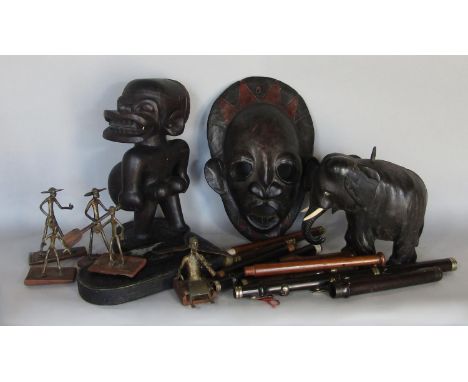 Tribal Art: a wooden carved leather clad mask, a carved figure, an ebony elephant and a five piece 'wire' band and components