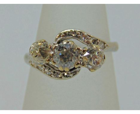 Early 20th century diamond crossover style ring in white metal, centre stone 0.25cts approx, size J, 3.8g 