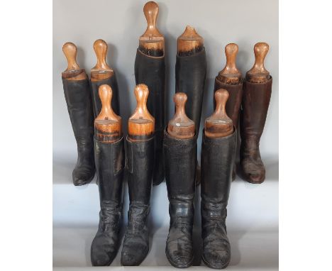 Five pairs of vintage black leather riding boots with vintage wooden boot trees 