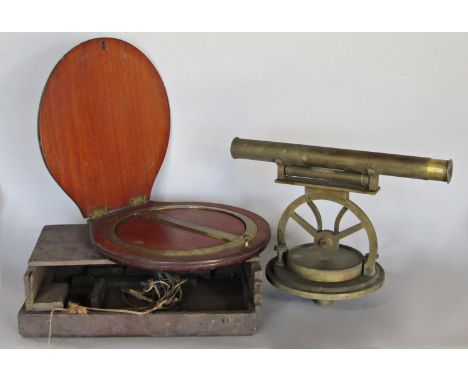 A brass surveyors site with compass below made by Cox, Plymouth Dock and the remains of a wooden box with a brass circular pr