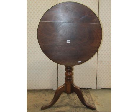 A 19th century mixed wood snap top occasional table of circular form raised on a ring turned pillar and swept tripod, 60 cm d