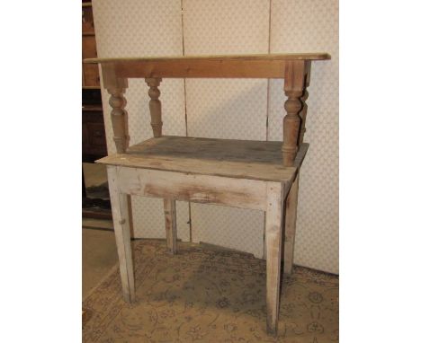 An antique painted pine kitchen side table, with rectangular overhanging boarded top, over a central frieze drawer with squar