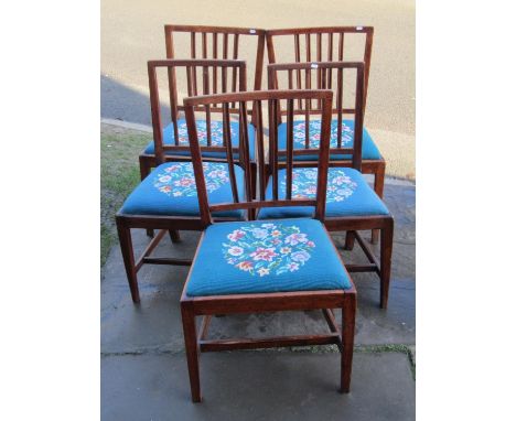 A matched set of five Georgian countrymade stick back dining chairs, in mixed woods including fruitwood and elm, all with han