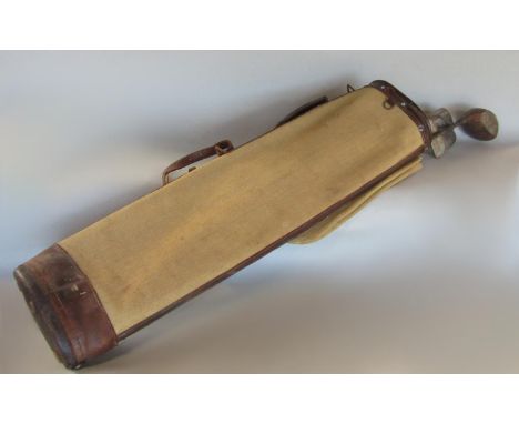 A vintage canvas and leather golf bag and four clubs 