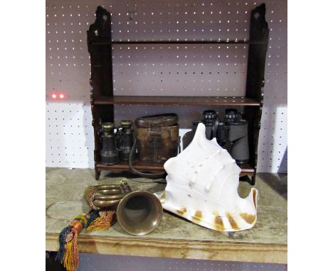 A large conch shell, brass military style bugle, Victorian mahogany book rack, a vintage pair of binoculars in a leather case