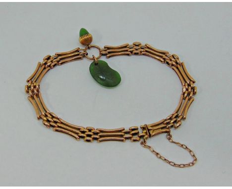 Antique 9ct gate link bracelet with nephrite jade acorn and four-leaf clover charms, 10.2g (one link near clasp vacant) 