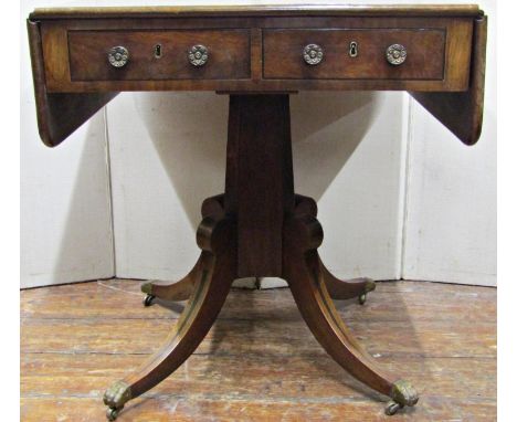 An unusually small Regency mahogany sofa table, the top with cross banded borders, fitted with two real and two dummy drawers