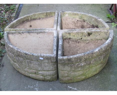 A reclaimed four sectional garden planter forming a circle, with mock stone wall effect, stamped to interior 'Willow Cottage 