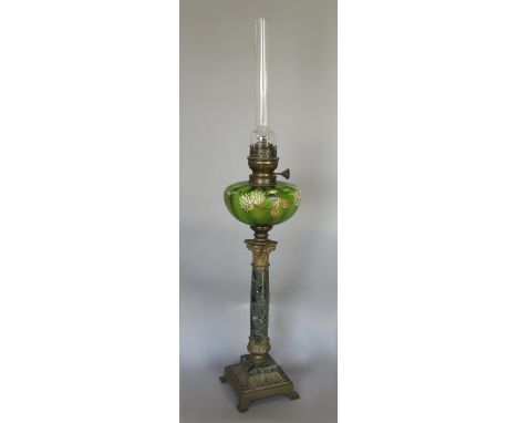 An oil lamp, floral green glass font, raised on a marble corinthian column decorative brass base, 80 cm high 