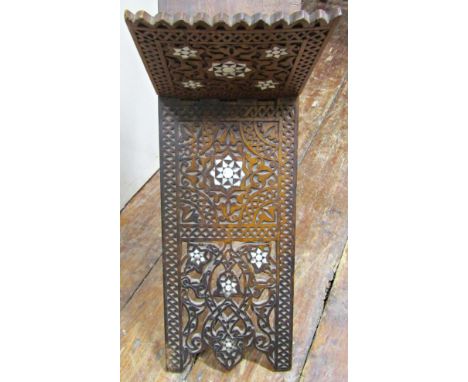 A Quran stand with profusely carved geometric and mother of pearl inlaid detail together with a further carved occasional tab