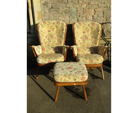 An Ercol Windsor two seat cottage sofa with stained beechwood frame and loose cushions together with a pair of matching armch