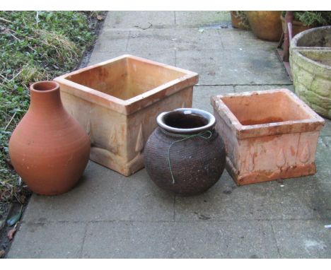 A square terracotta garden planter with tree moulded detail, 42cm square x 30cm high, together with a matching smaller exampl