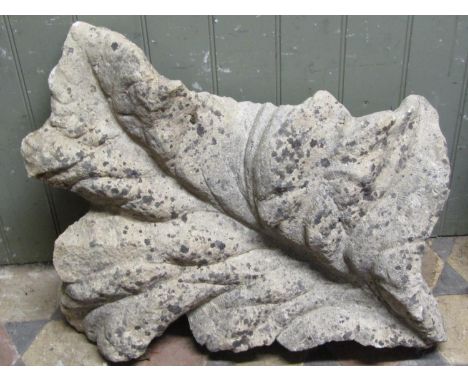 A carved natural stone architectural/garden ornament in the form of a leaf/foliage, 70 cm x 54 cm 