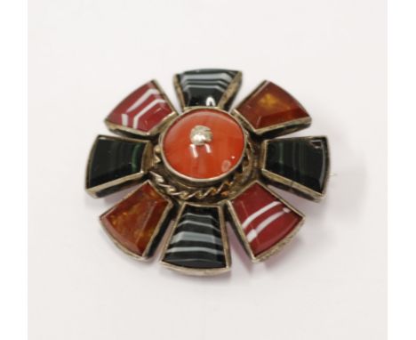 VICTORIAN SILVER COLOURED METAL AND SCOTCH PEBBLE BROOCH, of eight petal flower head shapes, 1 1/2" diameter 