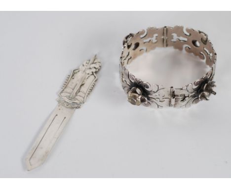 MEXICAN 'SILVER' BANGLE comprising four curved and hinged panels (one hinge faulty) of fret pierced foliate scrolls, each set
