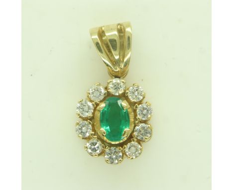 18ct gold pendant, set with an oval-cut emerald surrounded by ten diamonds, 3.3g. UK P&amp;P Group 0 (£6+VAT for the first lo