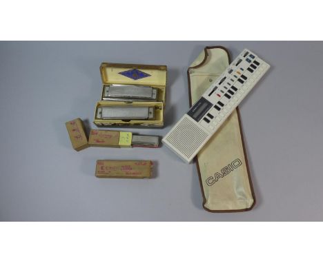 A Collection of Hohner Mouth Organs and a Casio VL-Tone (Electronic Musical Instrument) 