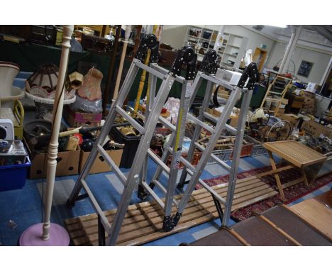 A Decorators Four Section Aluminum Ladder, Trestle and Set of Taps 