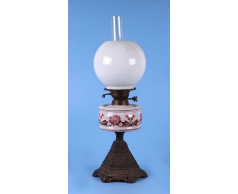 A Victorian oil lamp with opaque glass reservoir with floral decoration, an opaque glass circular lampshade on a pierced spel