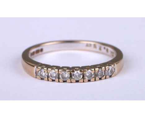 An 18ct gold diamond ring set with seven diamonds approximately 0.25ct, approx UK size 'P', 3g.