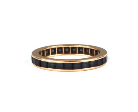 A yellow metal sapphire eternity ring, approx UK size 'K', 2g.